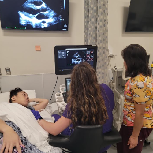 Student performing ultrasound on another student