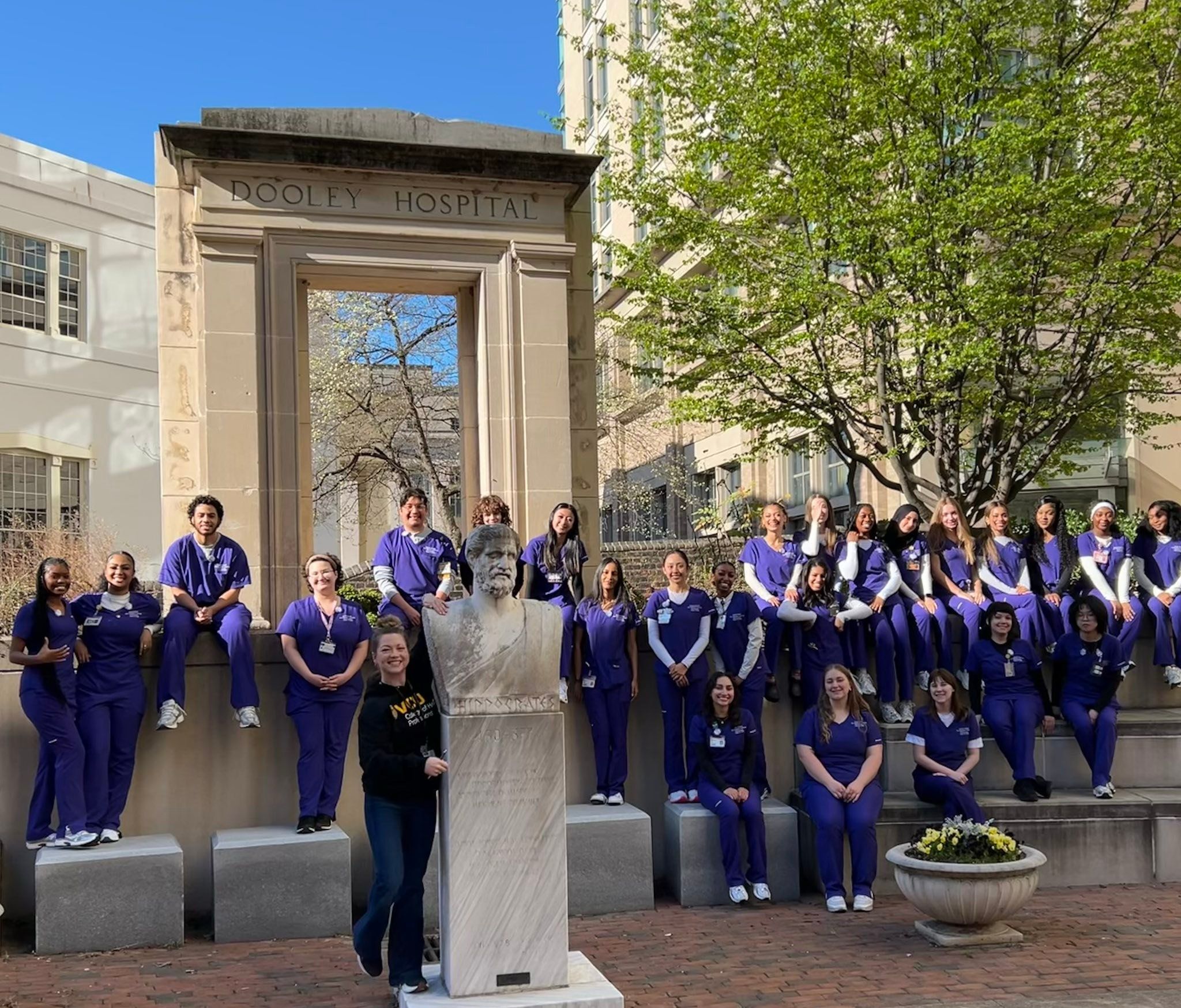 Radiography class of 2028 cohort with statue