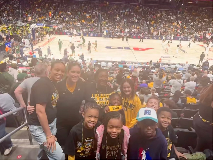 Three graduates Kerry Cropper Tammy Koenig and April Johnson and their families at a VCU basketball game