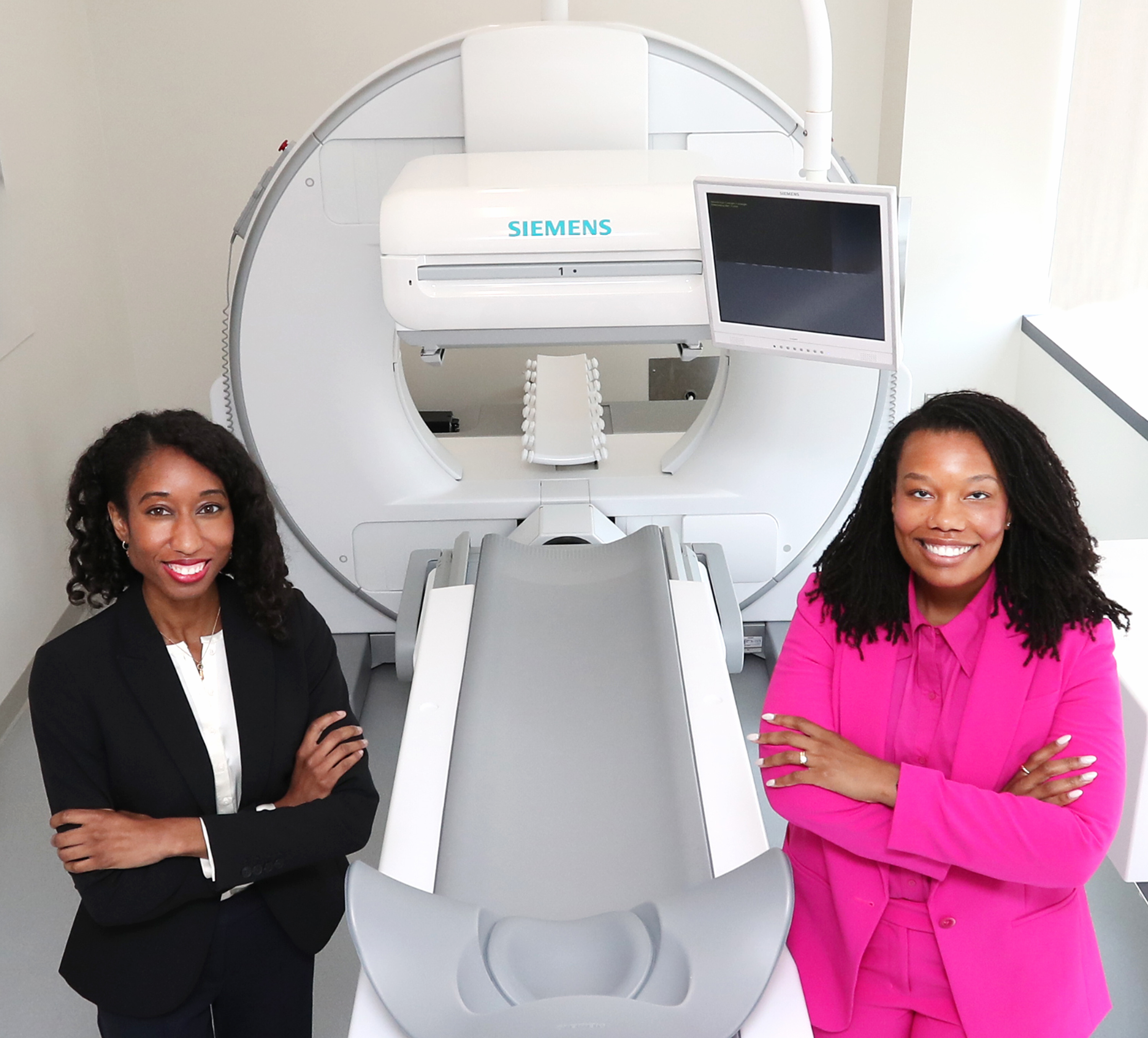 Heidy Palacios, MBA, director and assistant professor (left), and Charlie Downing, clinical coordinator (right) are pictured with the Siemens Symbia Evo Excel dual-head gamma camera system, which allows students to simulate nuclear medicine procedures in a controlled environment.