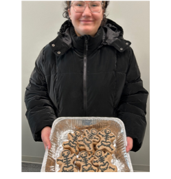Anna Navarro holding a tray of radiography themed cookies