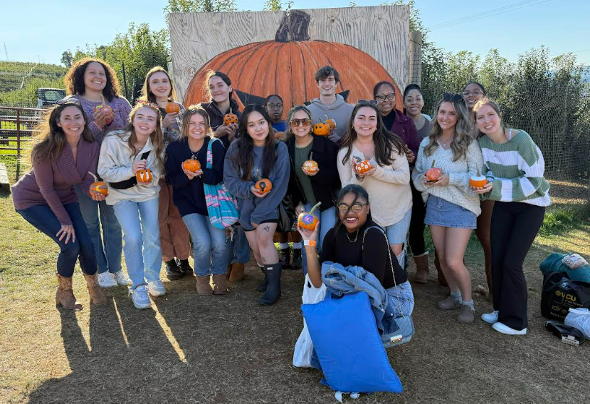 Class of 2025 and 2026 in front of pumpkin